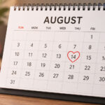 A calendar highlighting August with a heart symbol and a question mark, representing the viral August Dating Theory